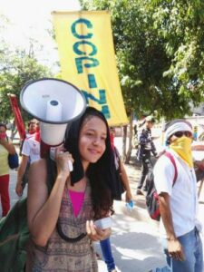 Young woman protesting with bullhorn